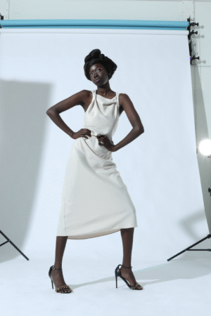 Model on set with a photography backdrop at the Bella Modeling School Dallas photography studio location.